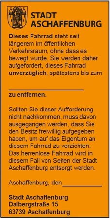 Bild vergr&ouml;&szlig;ern: Orangefarbener Aufkleber Schrottrad. Damit werden herrenlose Fahrräder markiert.