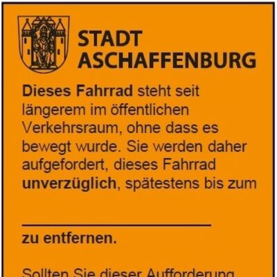 Orangefarbener Aufkleber Schrottrad. Damit werden herrenlose Fahrräder markiert. 