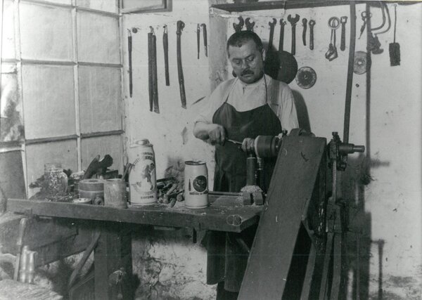 Zinngießer Johann Brandmüller an seiner Werkbank, um 1912 